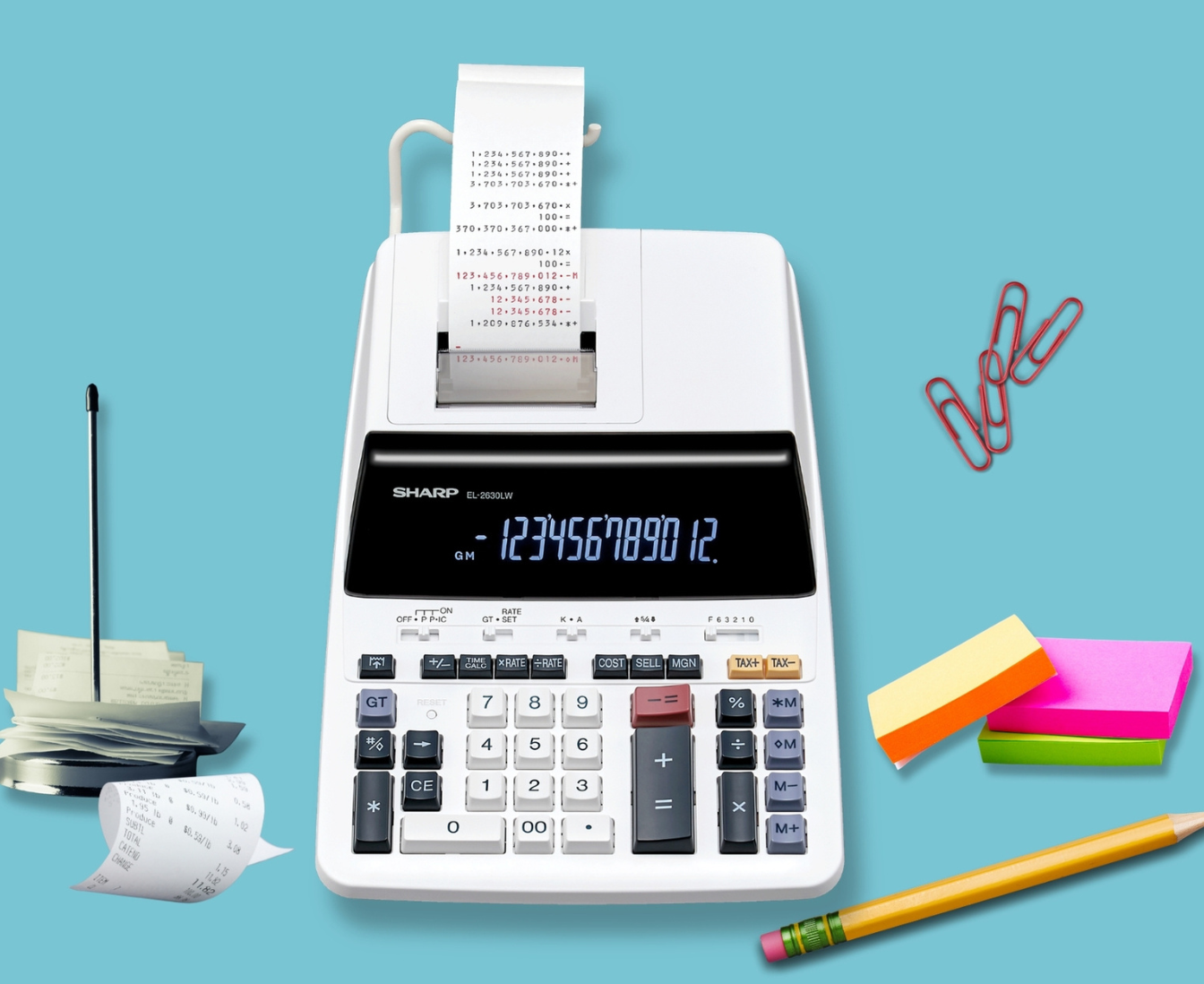 calculator top view with pencil, sticky notes and paper clip